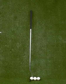 Modern-style golf club and three balls, late 20th century. Creator: Unknown