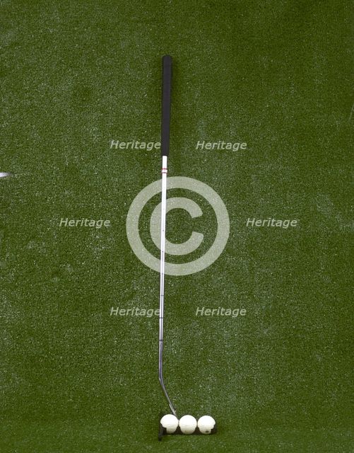 Modern-style golf club and three balls, late 20th century. Creator: Unknown.