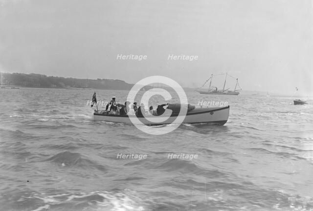 Modwena's motor launch with Modwena in the background, 1911. Creator: Kirk & Sons of Cowes.