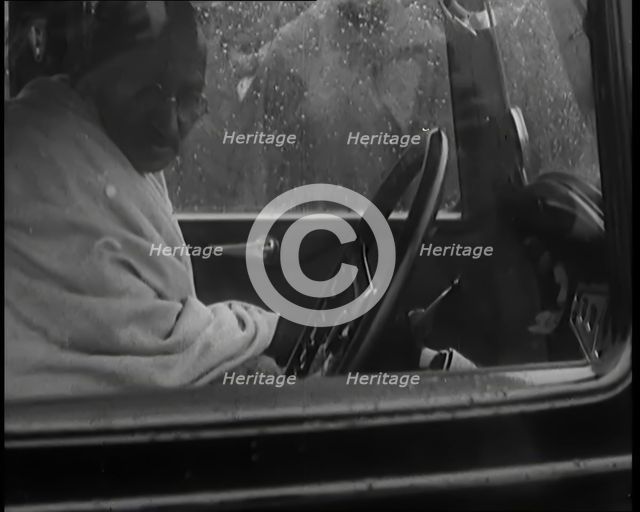 Mohandas K Gandhi (Mahatma) Sitting in a Car in the Rain, 1931. Creator: British Pathe Ltd.