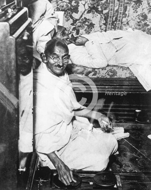 Mohondas Karamchand Gandhi (1869-1948), working at his spinning wheel. Artist: Unknown
