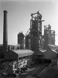 Molten steel being poured into rail trucks at the Stanton Steelworks, Ilkeston, Derbyshire, 1962. Creator: Michael Walters