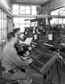Monotype keyboards in operation at a printing company, Mexborough, South Yorkshire, 1959. Creator: Michael Walters