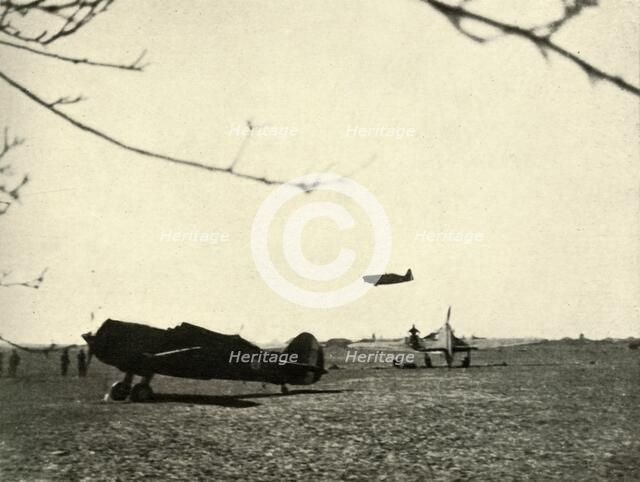 'Morane 406 at Vassincourt Aerodrome with French Curtiss Hawk and  Hurricane', 1939-1940, (1941). Creator: Unknown.