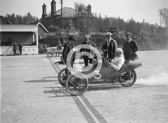 Morgan and Crouch cars on the start line of a motor race, Brooklands, 1914. Artist: Bill Brunell.