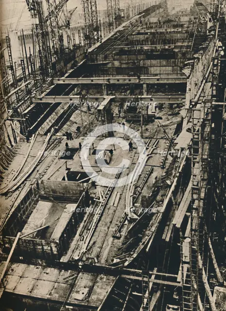 'More than 1,000 Feet Long. Shell of Queen Mary in early days of construction',  1930-1934, (1936). Artist: Unknown.