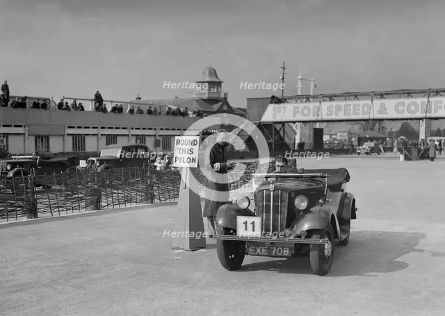 Morris 8 tourer competing in the JCC Rally, Brooklands, Surrey, 1939. Artist: Bill Brunell.
