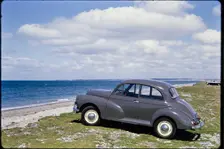 Morris Minor parked on the seafront, Traeth Llanddwyn, Anglesey, North Wales, 1962. Creator: Norman Barnard