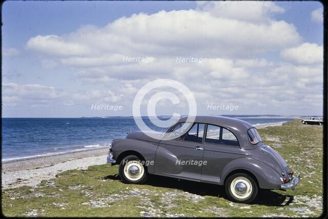Morris Minor parked on the seafront, Traeth Llanddwyn, Anglesey, North Wales, 1962. Creator: Norman Barnard.