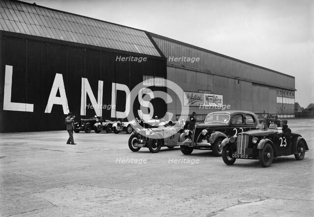 Morris, Ford V8 and MG PA Midget cars at the MCC Members Meeting, Brooklands, 10 September 1938. Artist: Bill Brunell.