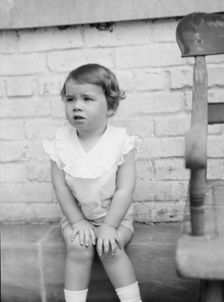 Moseley, F.S., Mr., child of, seated outdoors, 1930 May 24. Creator: Arnold Genthe