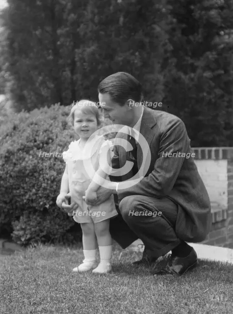 Moseley, F.S., Mr., and child, outdoors, 1930 May 24. Creator: Arnold Genthe.