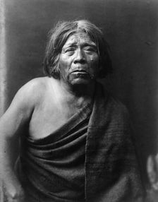 Mat Stams-Maricopa, half-length portrait, facing front, wrapped in blanket, c1907. Creator: Edward Sheriff Curtis