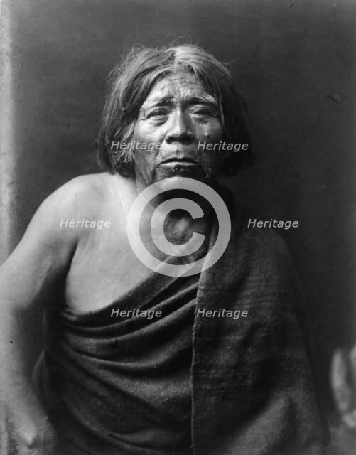 Mat Stams-Maricopa, half-length portrait, facing front, wrapped in blanket, c1907. Creator: Edward Sheriff Curtis.