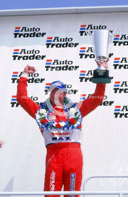 Matt Neal, Nissan driver, celebrates victory, 1999 British touring cars. Artist: Unknown.