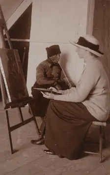 Maud Sherwood painting a dutchman with a clay pipe, 1913. Creator: Unknown