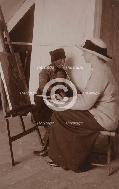 Maud Sherwood painting a dutchman with a clay pipe, 1913. Creator: Unknown.