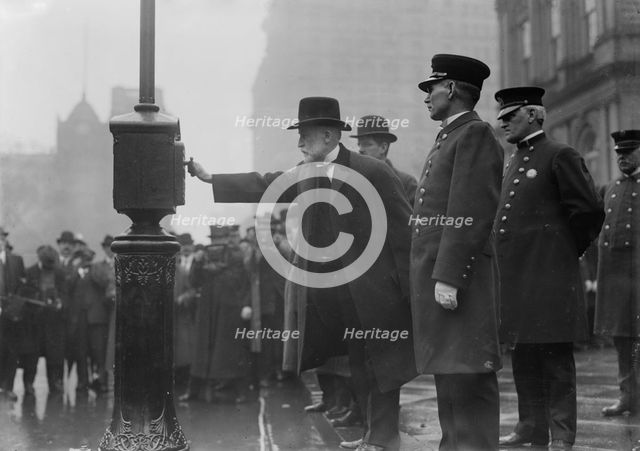 Mayor Gaynor turning in alarm 3/20/13, 1913. Creator: Bain News Service.