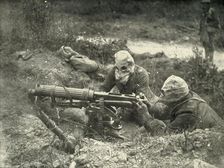 Machine Gunners in Action Wearing their Gas Helmets (1919). Creator: Unknown