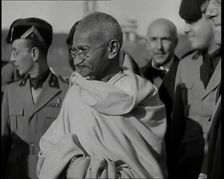 Mahatma Gandhi Standing with Others, 1930s. Creator: British Pathe Ltd