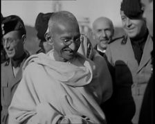 Mahatma Gandhi Standing with Others, 1930s. Creator: British Pathe Ltd