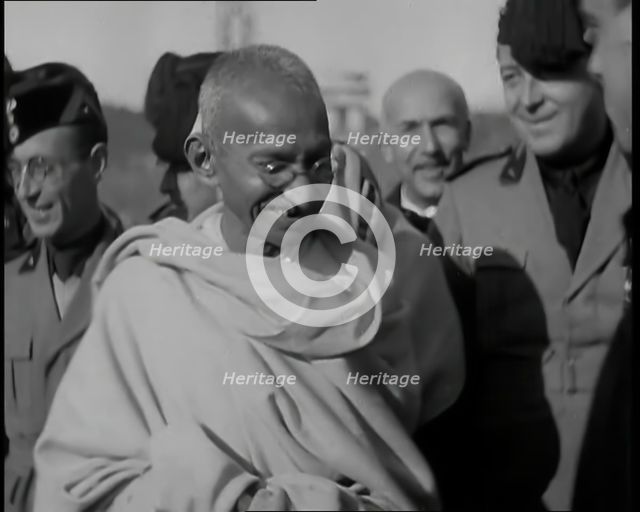 Mahatma Gandhi Standing with Others, 1930s. Creator: British Pathe Ltd.