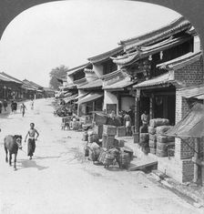 Main business street of the Chinese quarter, Bhamo, Burma, 1908. Artist: Stereo Travel Co