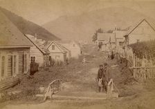 Main street in Petropavlovsk in Kamchatka. View of Mishennaya Sopka, 1890. Creator: Unknown
