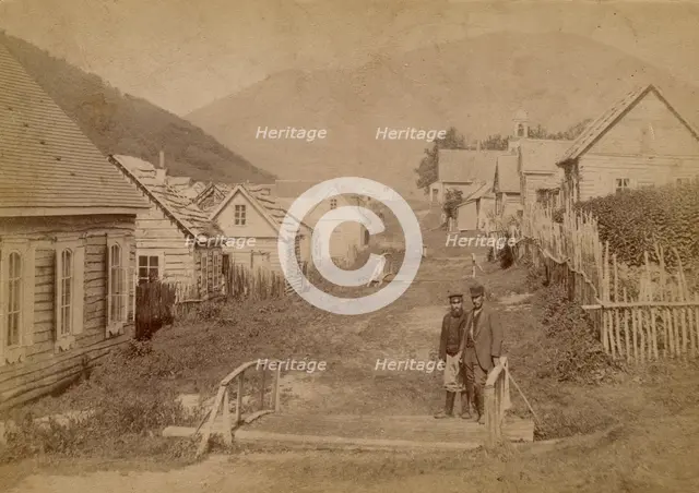 Main street in Petropavlovsk in Kamchatka. View of Mishennaya Sopka, 1890.  Creator: Unknown.