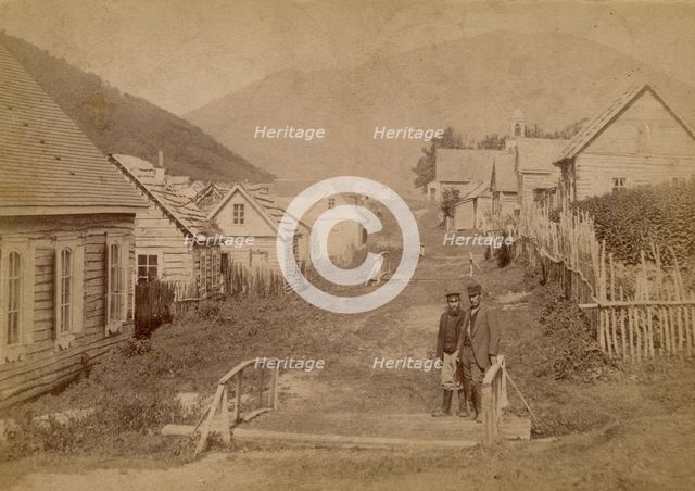 Main street in Petropavlovsk in Kamchatka. View of Mishennaya Sopka, 1890.  Creator: Unknown.
