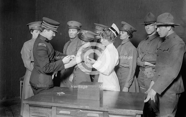 Major Connell inoculating woman motorist, 29 May 1917. Creator: Bain News Service.