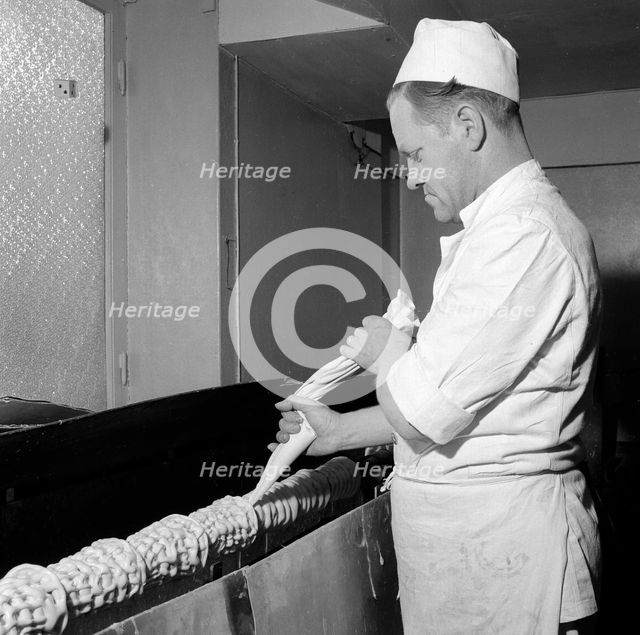 Making a Baumkuchen ('tree cake'), Landskrona, Sweden, 1952. Creator: Unknown.