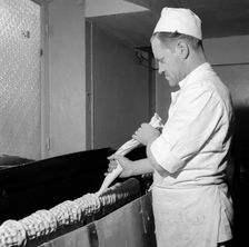 Making a Baumkuchen ('tree cake'), Landskrona, Sweden, 1952. Creator: Unknown