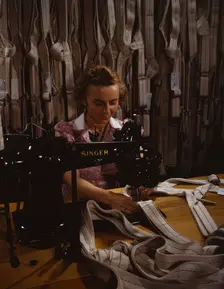 Making harnesses, Mary Saverick stitching, Pioneer Parachute Company Mills, Manchester, Conn., 1942. Creator: William Rittase