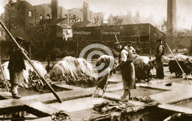 Making leather in the lime yard at Neckinger Mills, London, 20th century. Artist: Unknown