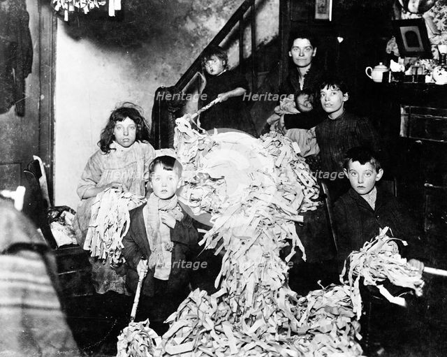 Making party streamers at home, London, c1900. Creator: Unknown.