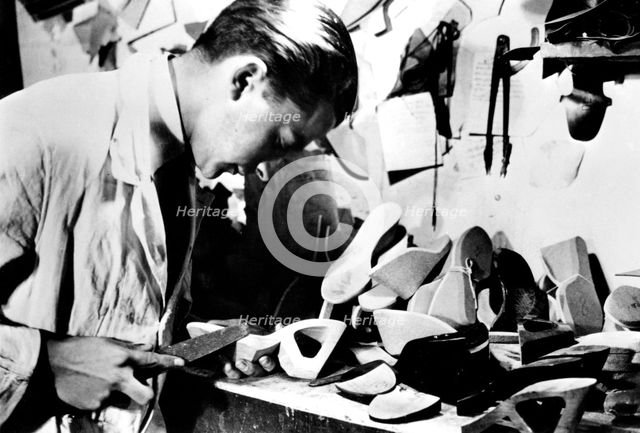 Making wooden shoe soles, German-occupied Paris, February 1941. Artist: Unknown