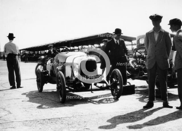 Malcolm Campbell and a Talbot car in the Paddock at Brooklands, Surrey, June 1923. Artist: Unknown