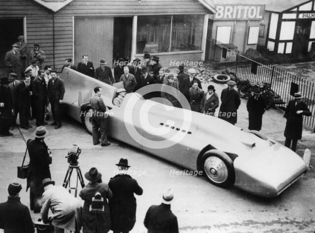 Malcolm Campbell being photographed in Bluebird, 1935. Creator: Unknown.
