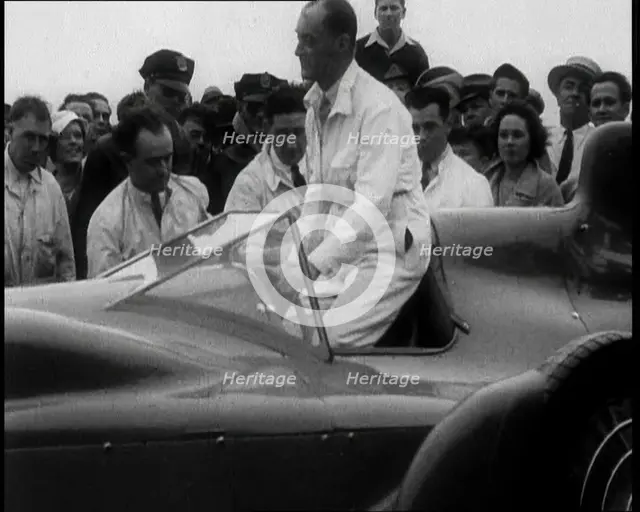 Malcolm Campbell Entering a Car While a Crowd Watches, 1933. Creator: British Pathe Ltd.