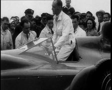 Malcolm Campbell Entering a Car While a Crowd Watches, 1933. Creator: British Pathe Ltd
