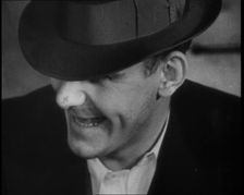 Male American Civilian Wearing a Hat Sitting at a Desk, 1930. Creator: British Pathe Ltd