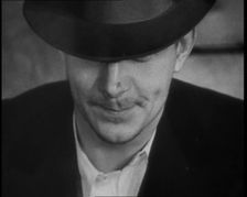 Male American Civilian Wearing a Hat Sitting at a Desk, 1930. Creator: British Pathe Ltd