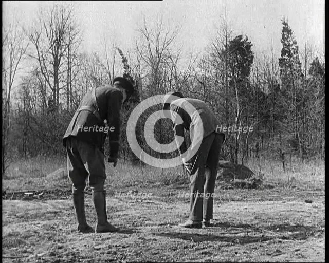 Male American Police Officers Investigating Footprints Outside American Aviator Charles..., 1930s. Creator: British Pathe Ltd.