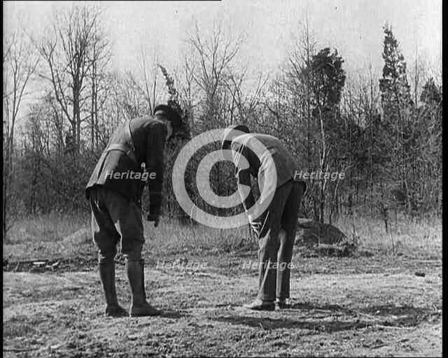 Male American Police Officers Investigating Footprints Outside American Aviator Charles..., 1930s. Creator: British Pathe Ltd.