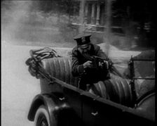 Male American Police Officers on a Car Shooting a Gunmachine on Persue, 1930. Creator: British Pathe Ltd
