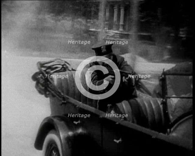 Male American Police Officers on a Car Shooting a Gunmachine on Persue, 1930. Creator: British Pathe Ltd.