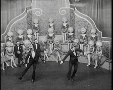 Male and Female Actors in Costumes Performing a Dance Routine On Stage, 1920s. Creator: British Pathe Ltd