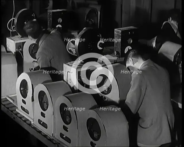 Male and Female Civilians Building Radio Wireless Sets in a Factory, 1931. Creator: British Pathe Ltd.