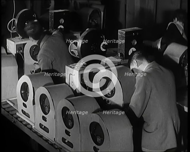 Male and Female Civilians Building Radio Wireless Sets in a Factory, 1931. Creator: British Pathe Ltd.